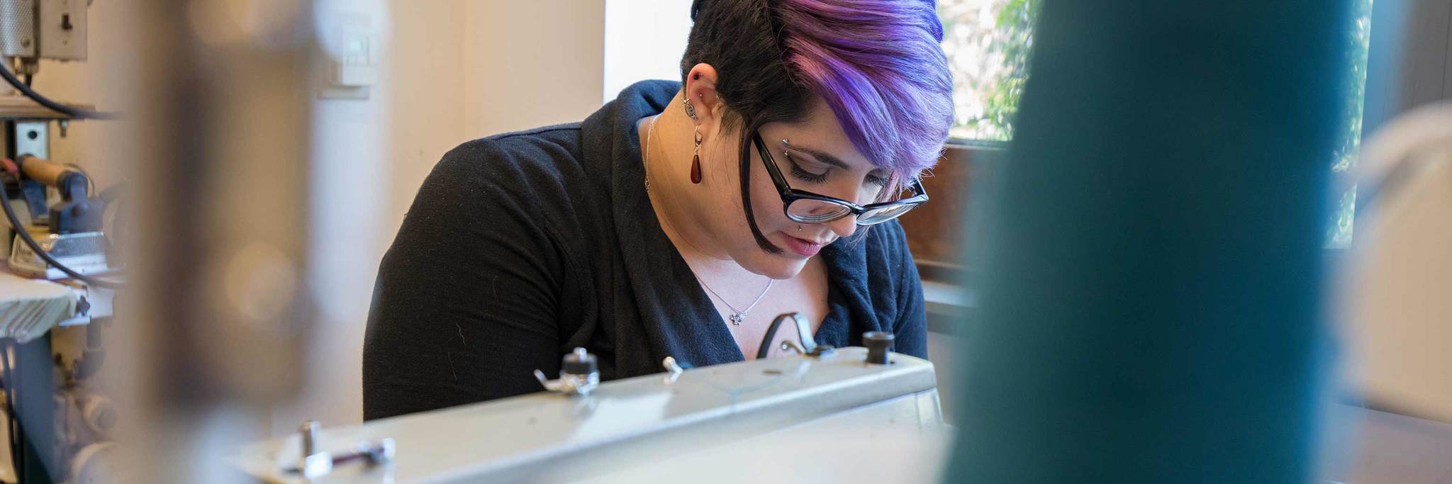 student working on a costume