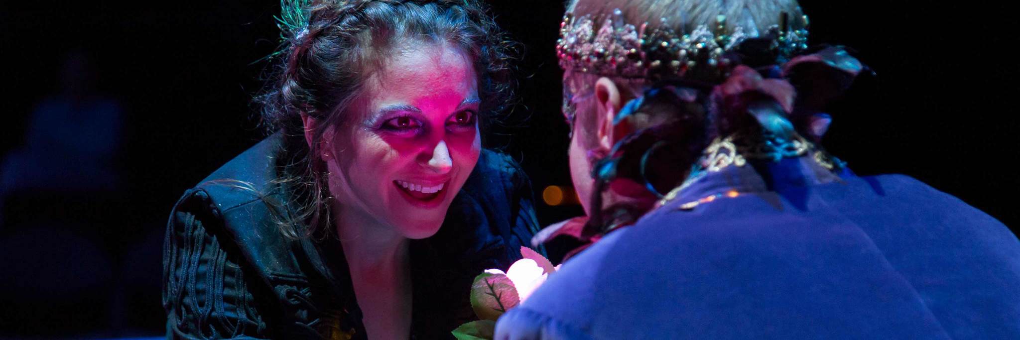 woman smiling during a scene on stage