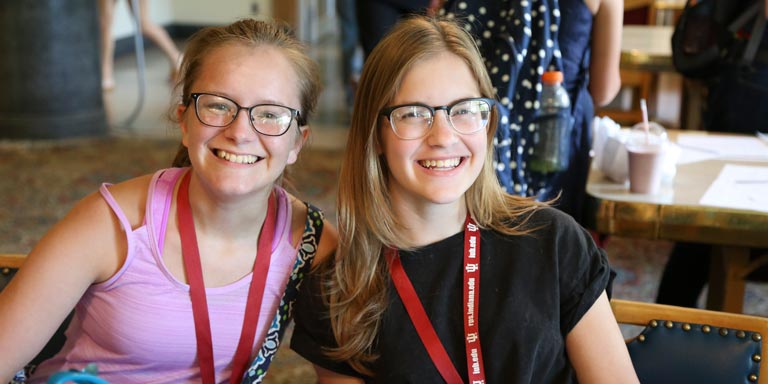 two students smile at camera