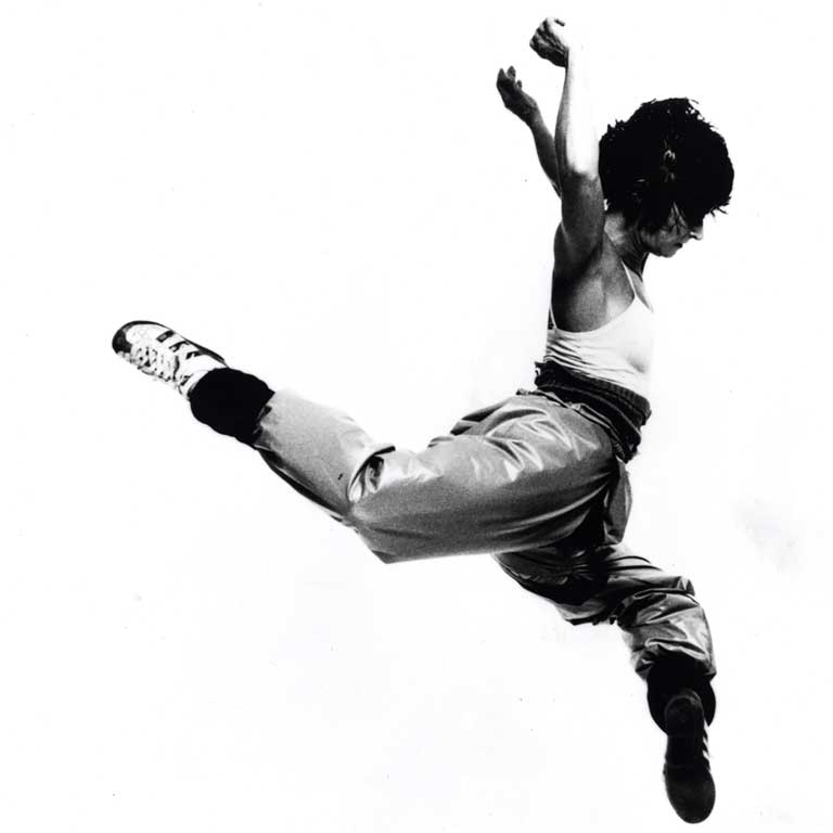 A stark black-and-white image of a dancer leaping.